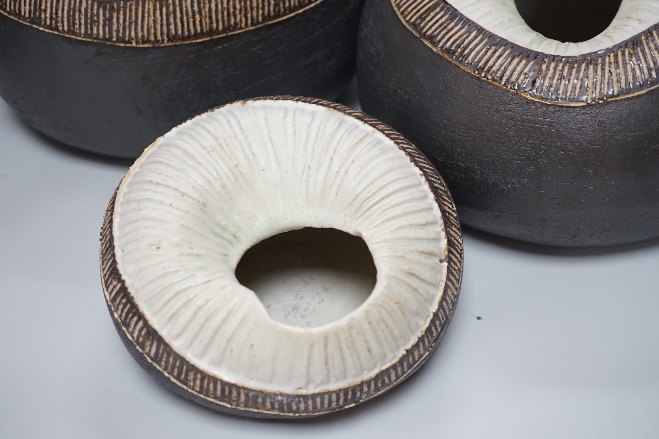 Ruth Sulke - a set of three graduated shell-like circular pottery vases, each inscribed R/S on base, tallest approximately 25cms high